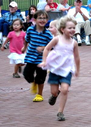 Little kids' running at a bluegrass concert