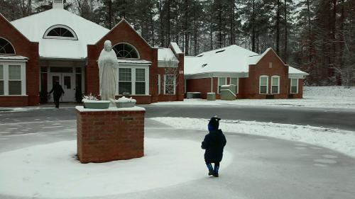 Toddler in the snow, in front of MiraVia residence