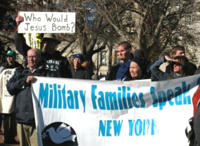 A banner for military families against escalation in Afghanistan and a sign that asks: 'Who Would Jesus Bomb?'