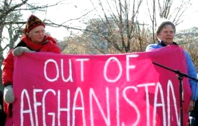 Two women hold pink banner: 'Out of Afghanistan'