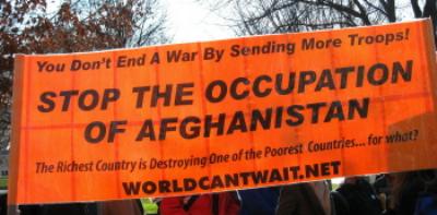 Orange Banner: 'You Don't End A War By Sending More Troops!/STOP THE OCCUPATION OF AFGHANISTAN'