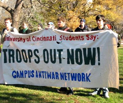 Young men hold banner--'University of Cincinnati Students Say: TROOPS OUT NOW!'