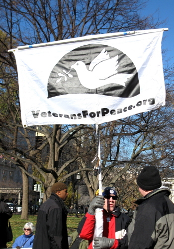 Demonstrator with Veterans for Peace banner