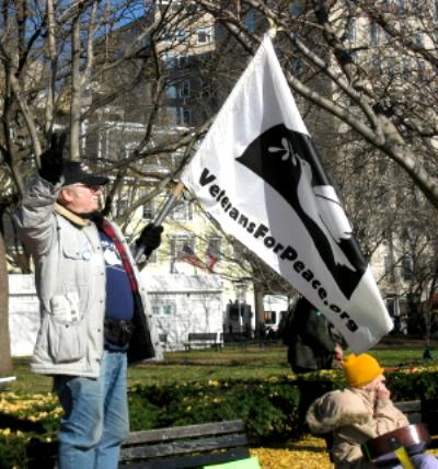 Man holds a Veterans for Peace flag
