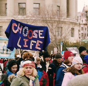 Demonstrators with colorful, quilted banner: 'Choose Life'