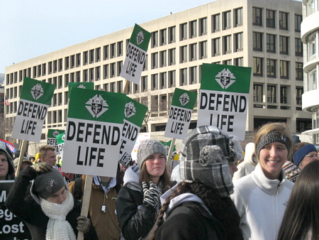 Young women with 'Defend Life' signs at the March for Life