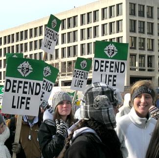 Young women with 'Defend Life' signs