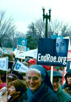 Marchers with 'EndRoe.org' and 'Defend Life' signs