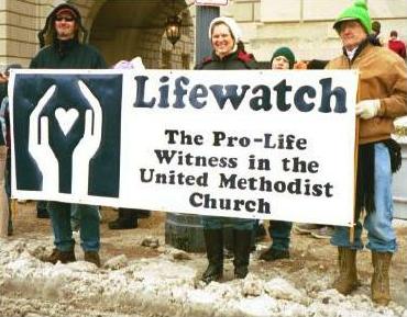 Activists hold banner: 'Lifewatch/The Pro-Life Witness in the United Methodist Church'