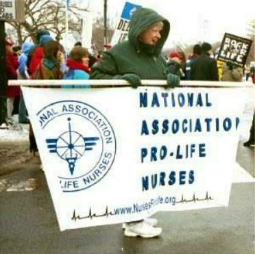 Nurse with banner: 'National Association 
Pro-Life Nurses'