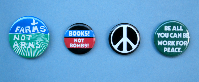 Selection of peace buttons, including 'Farms/Not Arms' and 'Books! Not Bombs!'