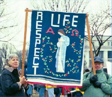 Couple carries 'Respect Life' banner