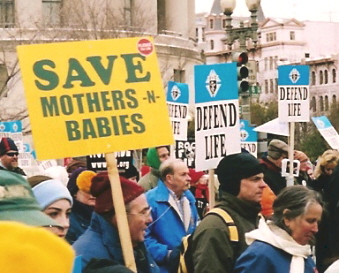 Marcher with sign: 'Save Mothers -N- Babies'
