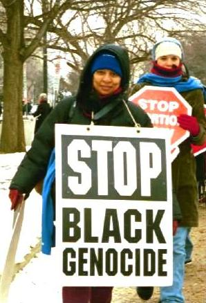 Woman with 'Stop Black Genocide' sign